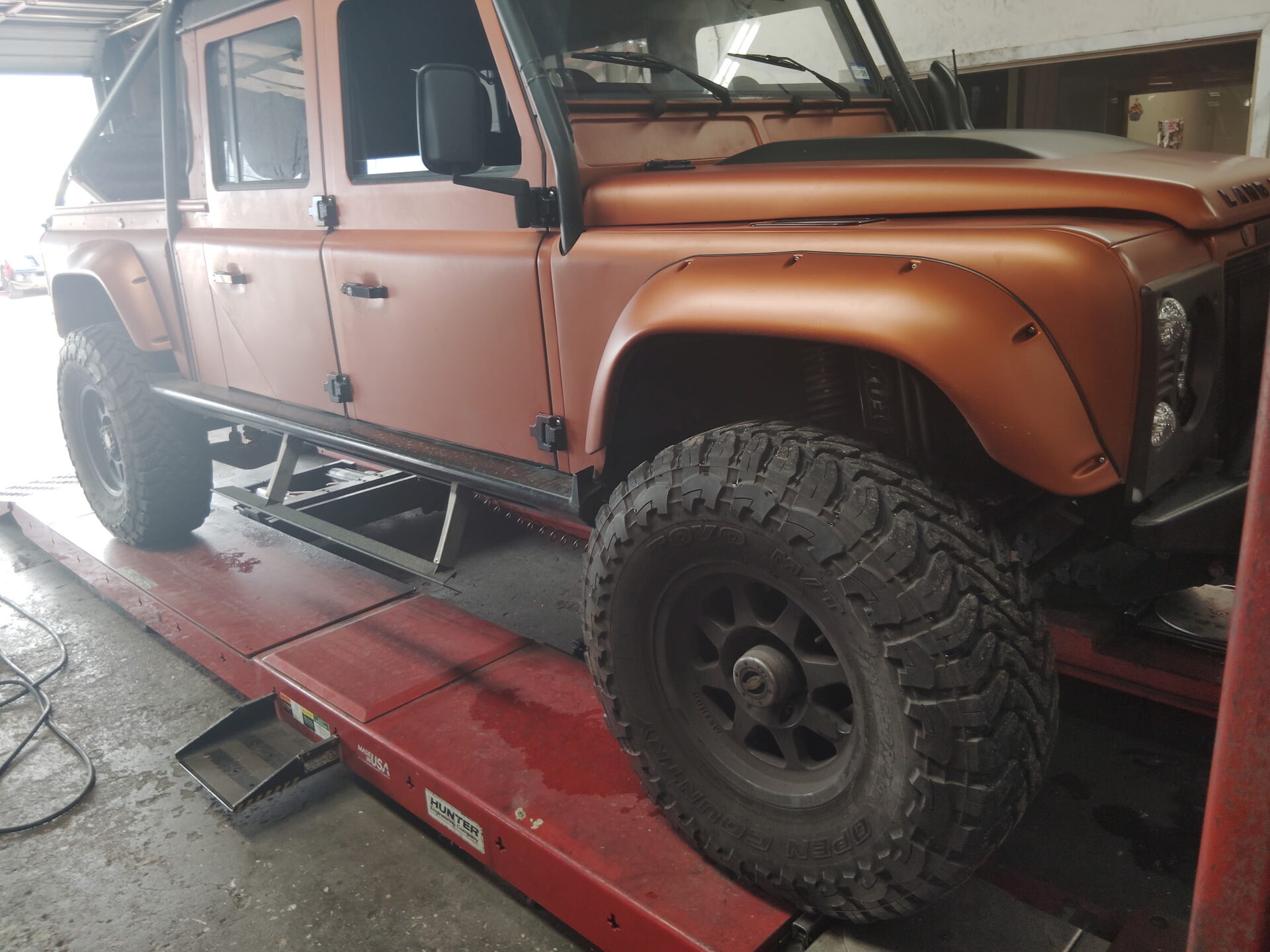 Land Rover Defender on a lift for mechanical service