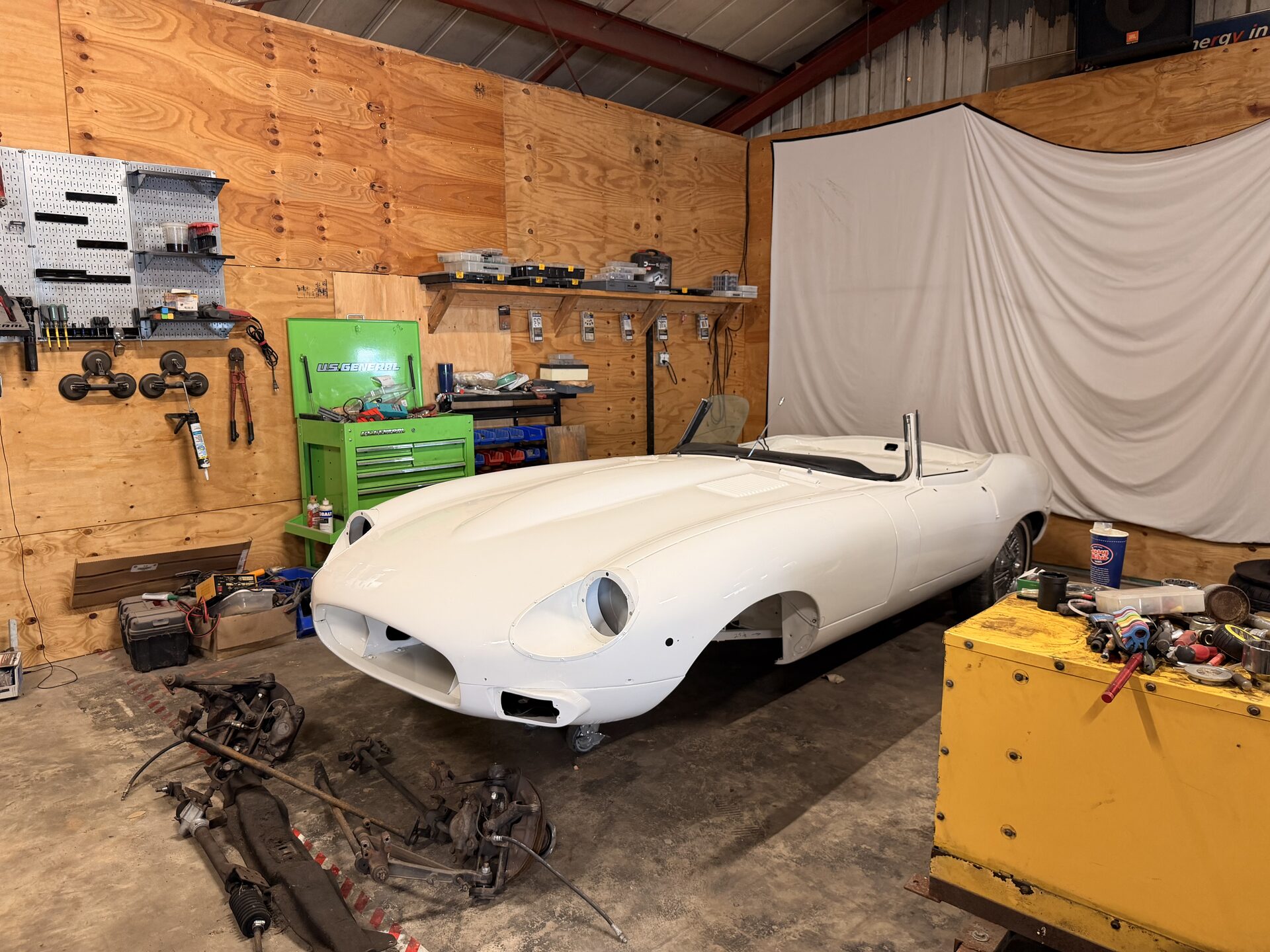 Jaguar E-Type body shell in the restoration bay