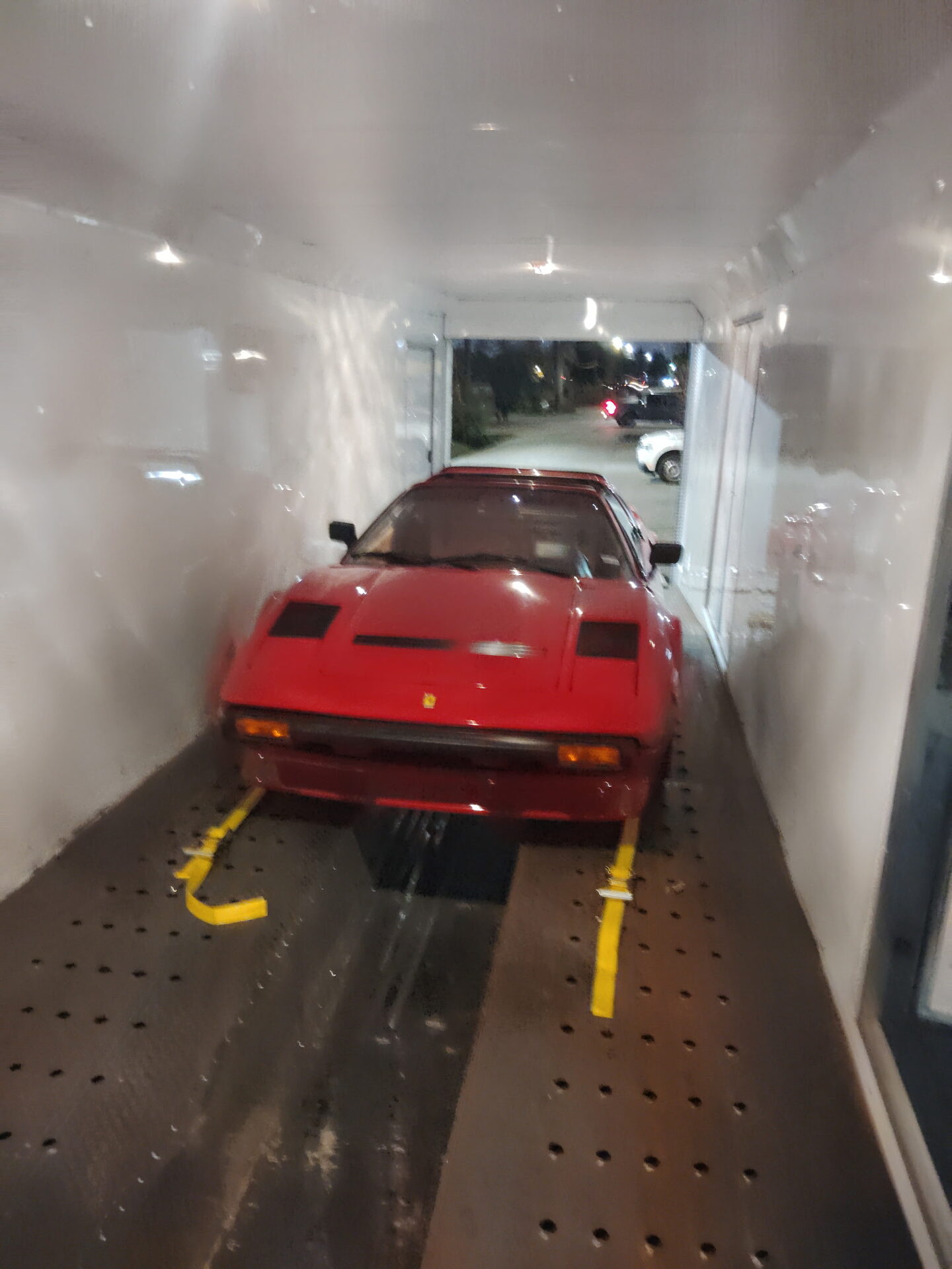 Ferrari loaded into an enclosed transport trailer