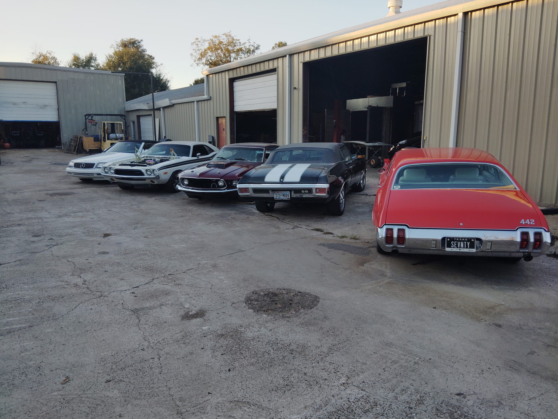 Lineup of American muscle cars at the shop