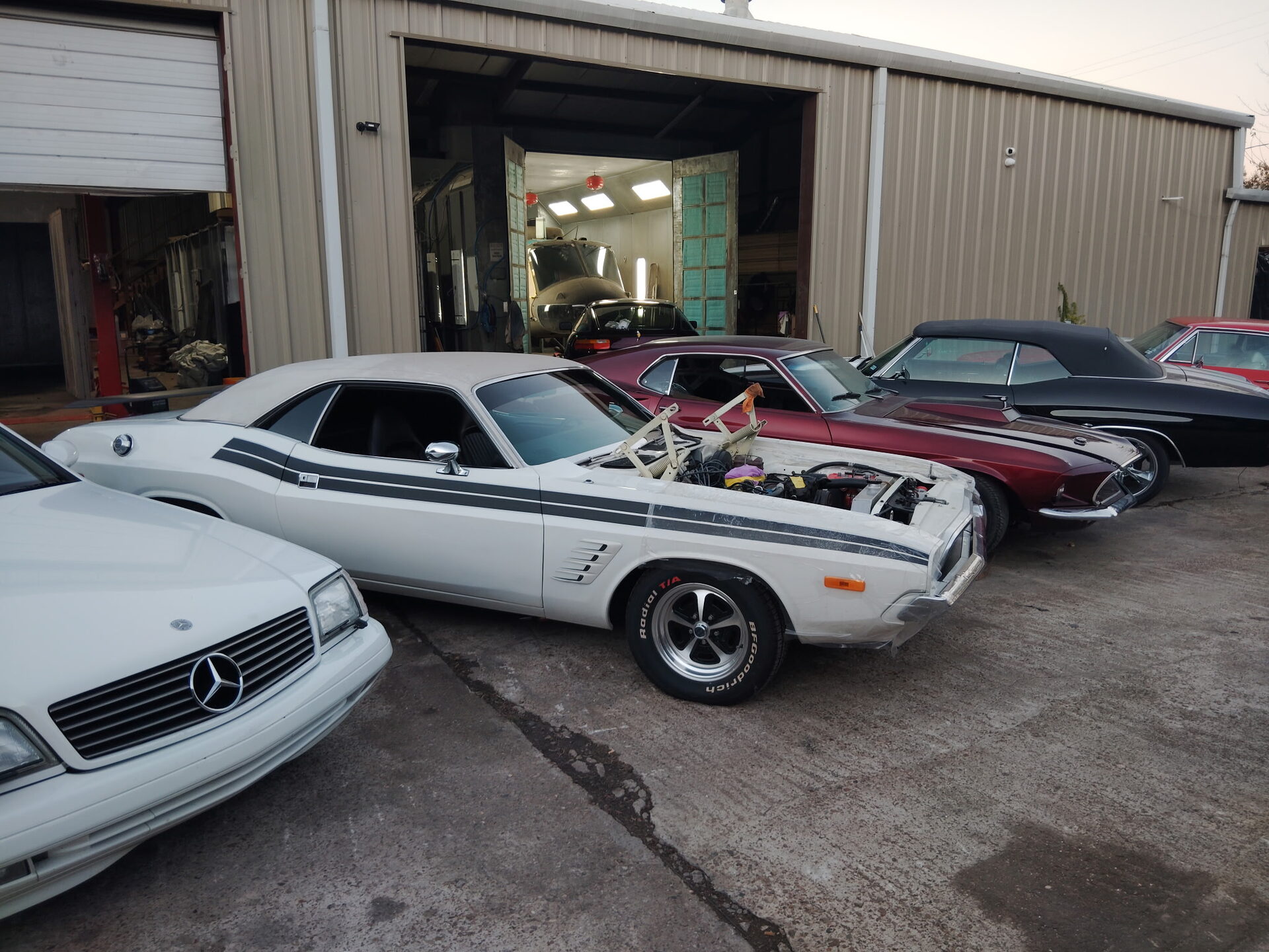 Muscle cars parked at the shop